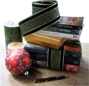 Photo of books, candles and holiday ornament